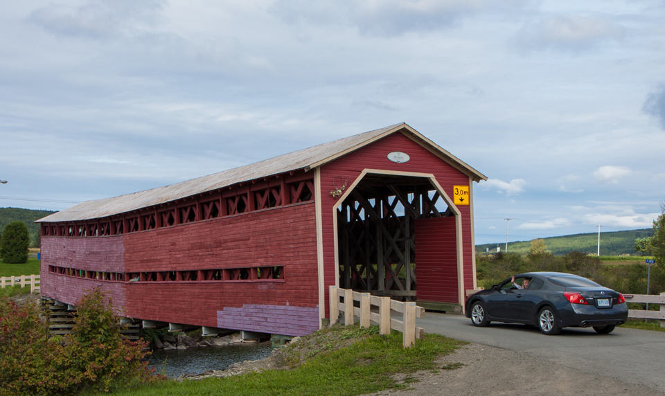 Driving across one of many covered bridges in New Brunswick