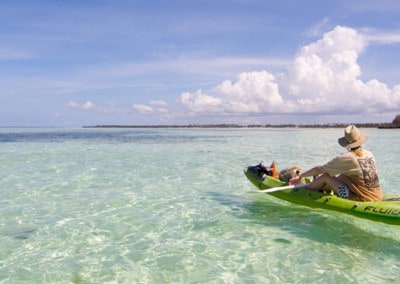 Jane in Kayak clear waters Pongwe Beach Zanzibar
