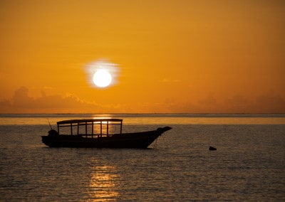 Zanzibar sunset Pongwe beach with silhouetted boat