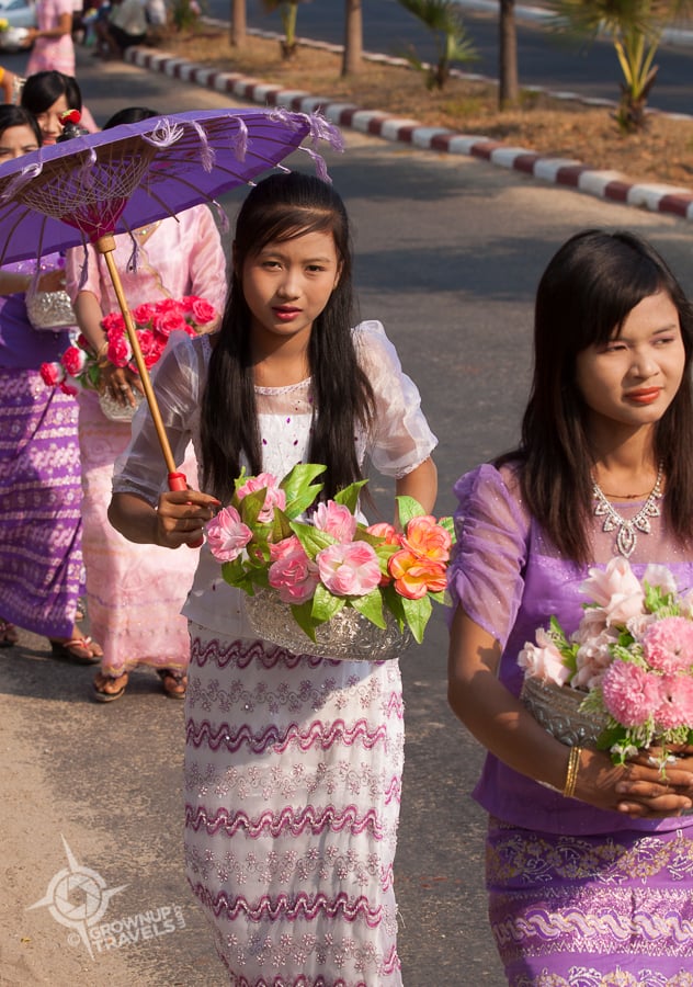 Relatives of the novices carry flowers, vases, and other ceremonial items