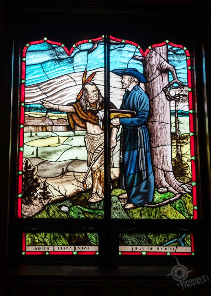 Jesuit and Indigenous person stained glass window Martyrs Shrine