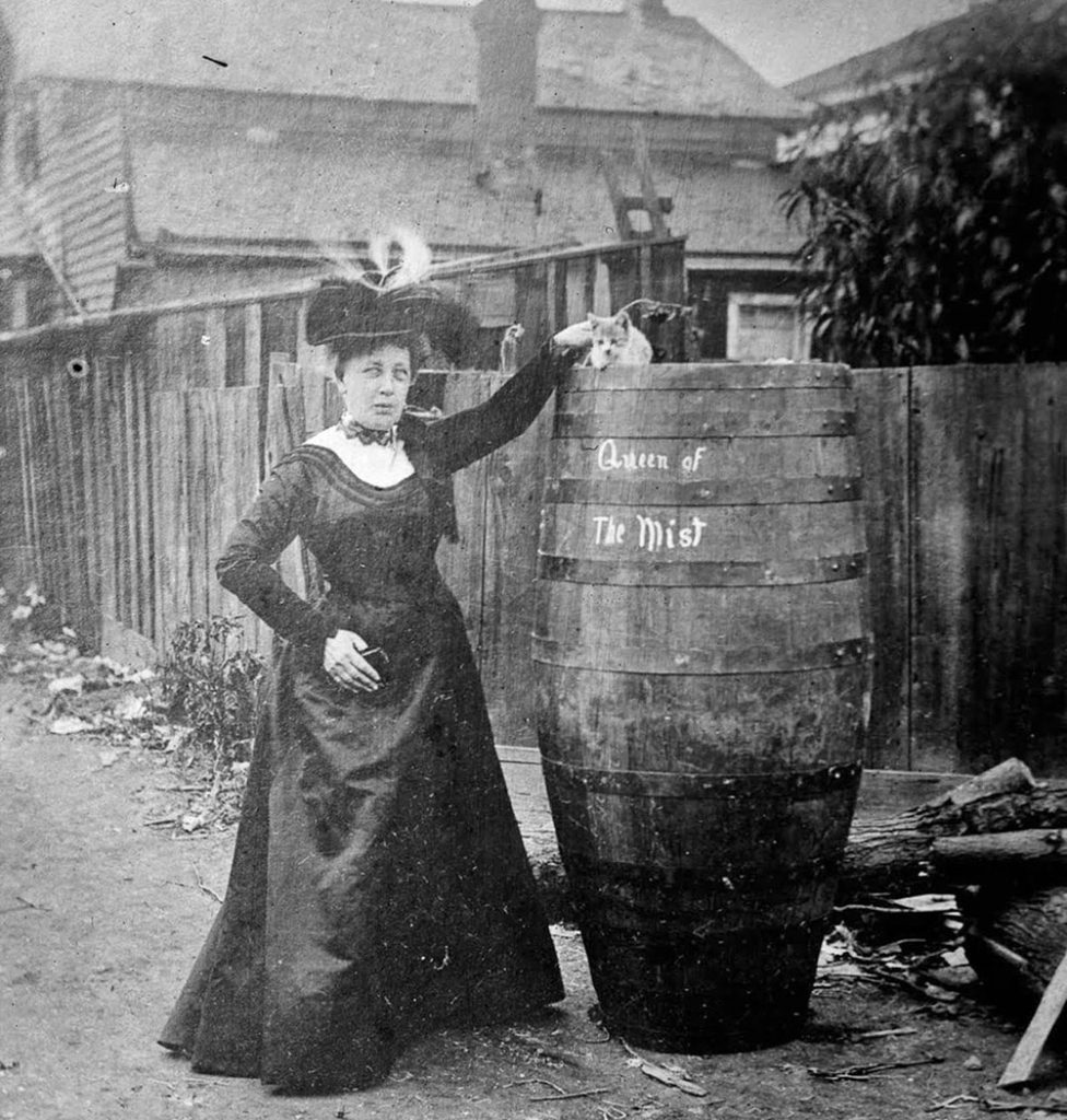 Annie-Edson-Taylor-poses-with-her-cat-and-the-barrel-she-rode-over-the-falls.-1901.-