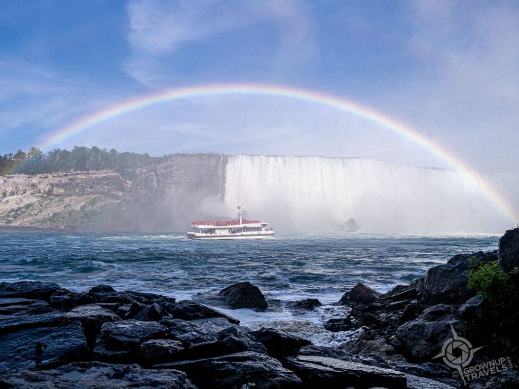 Tour boat approaching Horseshoe Falls under double rainbow