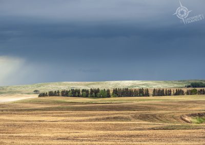 Rain clouds and snow dusting fields Alberta