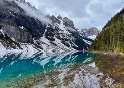 Reflections of mountains in turquoise Lake Louise Banff Alberta