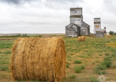 Pair of Grain Elevators and hay bale Horizon Saskatchewa