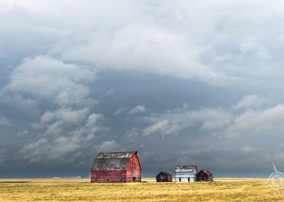 red barn and outbuildings with grey skies Saskatchewan-13-2
