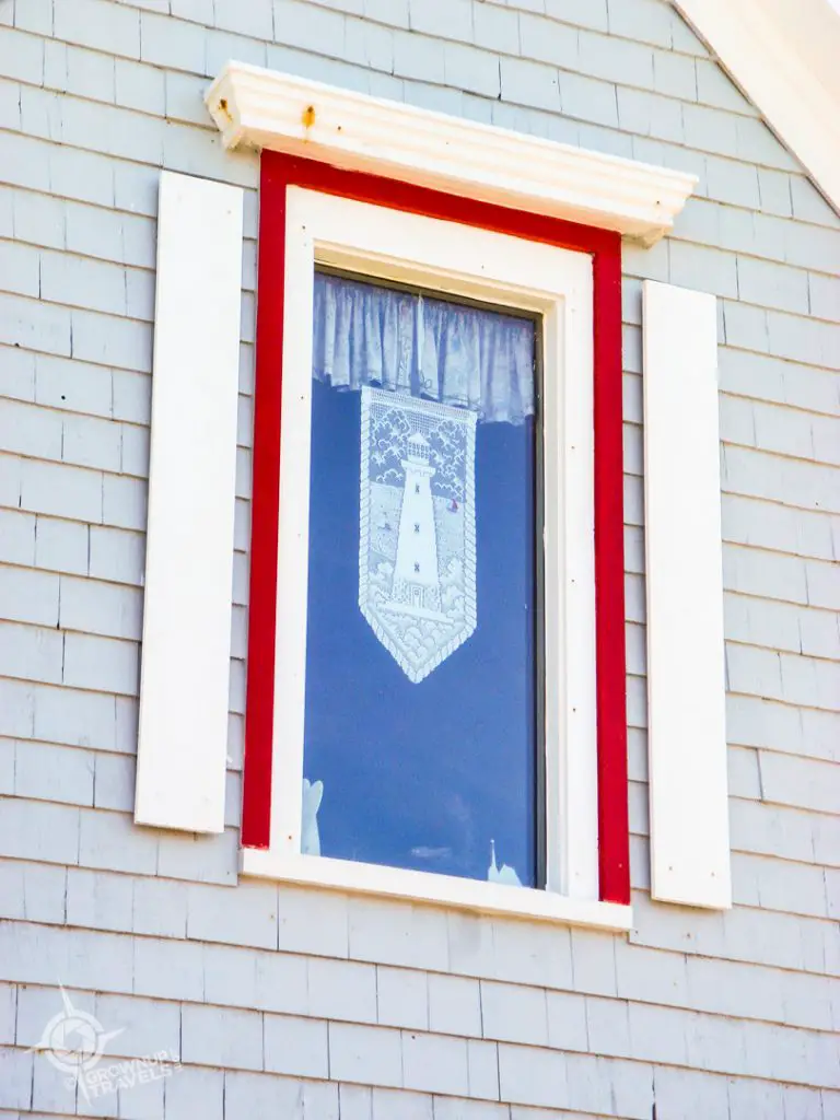 Peggy's Cove lace with lighthouse in pattern in window