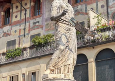 Piazza Erbe Madona di Verona statue with frescoed building behind