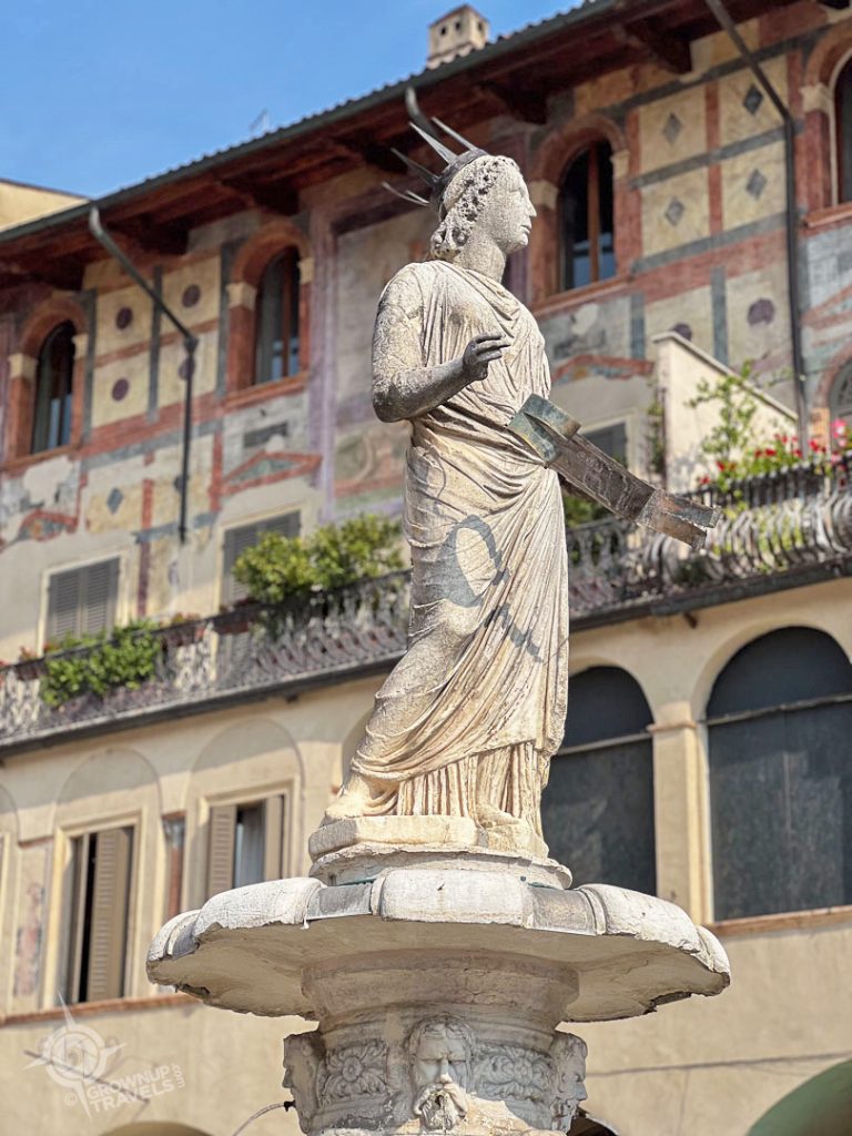 Piazza Erbe Madona di Verona statue with frescoed building behind