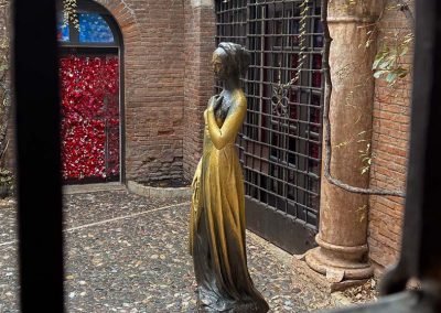 statue of Juliette seen through window Casa di Giulietta Verona