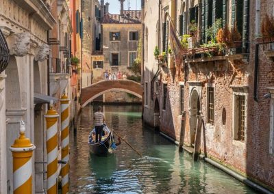 Gondolier late afternoon in canal Venice