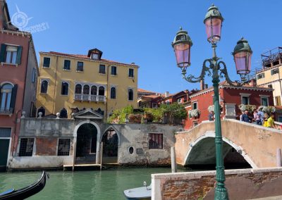Pink lampposts in Venice with bridge