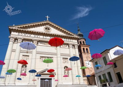 Cittadella colourful umbrellas in main piazza with church