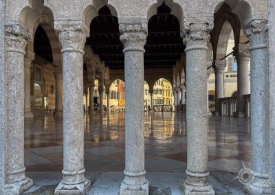 view into Loggia del Lionello through pillars Udine