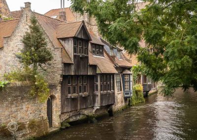 Wooden facades on canal houses near Love Bridge Bruges Belgium