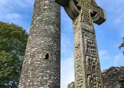 Cross and tower in Monasterboice cemetery Ireland