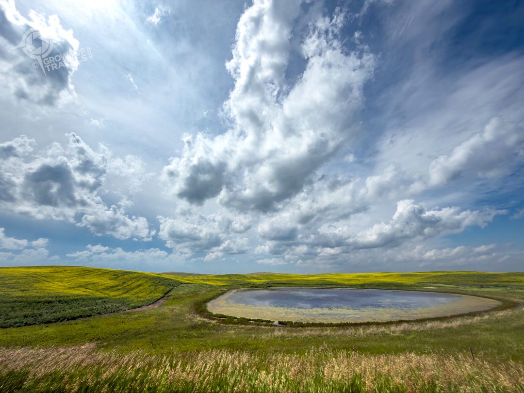 Storm Chasing Saskatchewan sunny skies with pond reflections